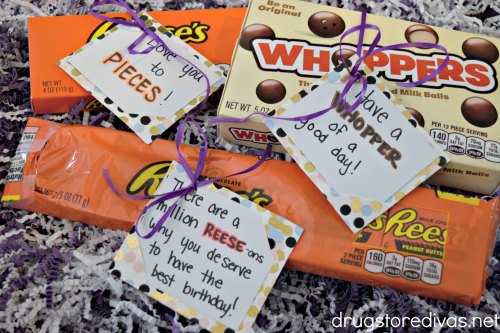 Three boxes of candy with hand tags on them that have candy puns on them.