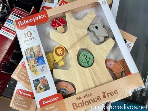 A stack of Fisher-Price Wooden Balance Tree Stacking Activity Toy boxes.