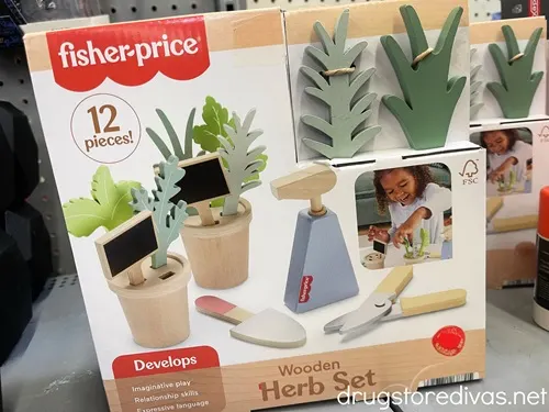 A Fisher-Price Wood Herb Garden box on the shelf.