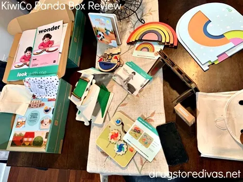 A bunch of wooden toys from a KiwiCo kit across a table.