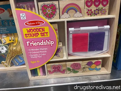 A Melissa & Doug Wooden Stamp set in a package on a shelf.
