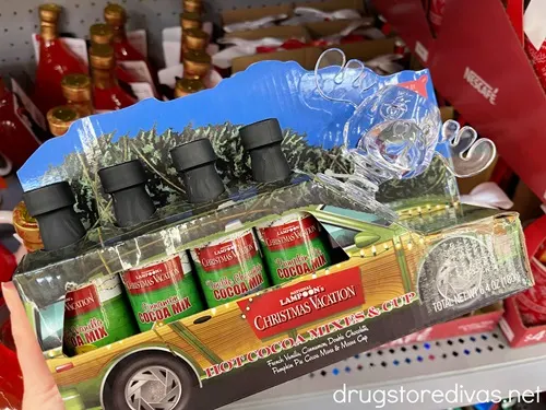 A paper station wagon with four hot chocolate mixes in it with a moose head-shaped mug with it.