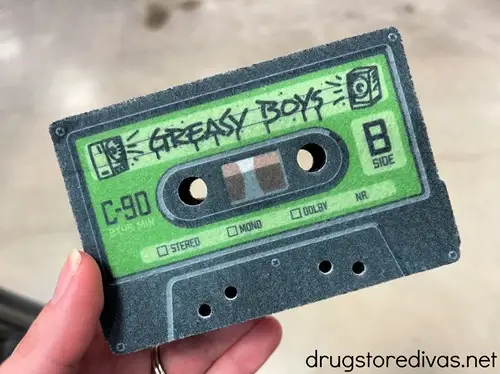 A sponge that's in the shape of a cassette table with a green label that says Greasy Boys.