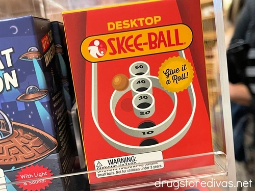 A desktop skee ball game on display in a store.