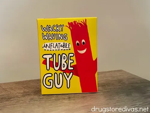 A desktop wacky waving inflatable tube guy in a box on a desk.