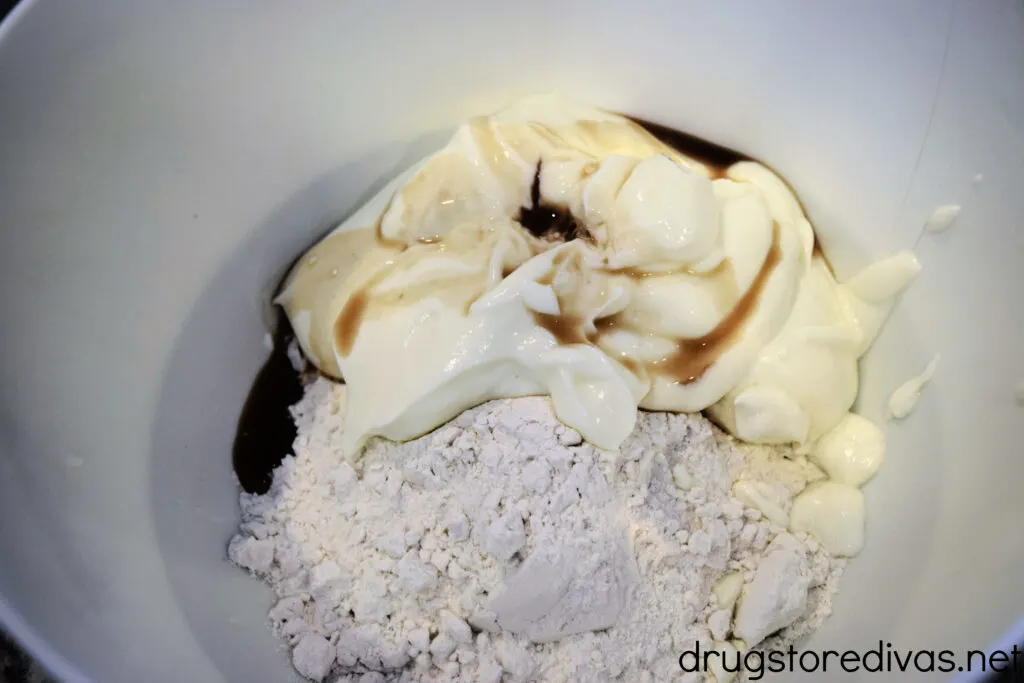 Flour, yogurt, and vanilla in a white bowl.