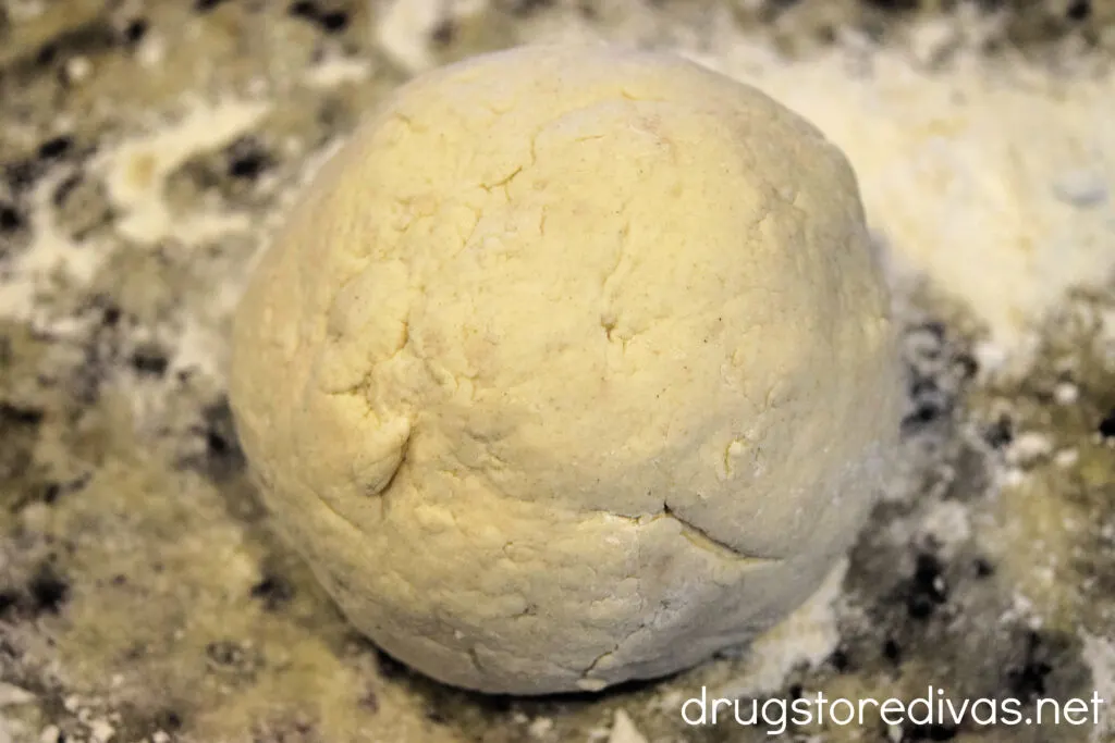 Dough ball on a floured countertop.