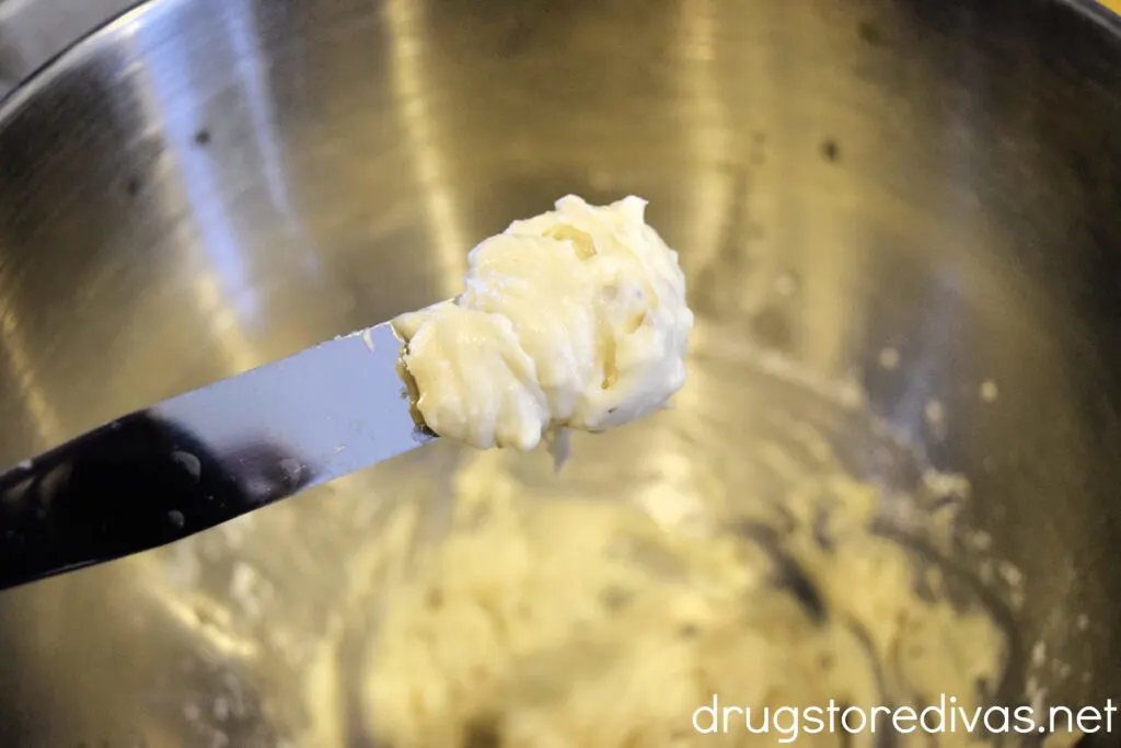 Cream cheese icing on a spatula. 