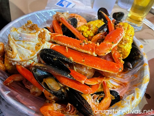 Crab legs, mussels, and corn in a bowl and Carolina Crab House in Wilmington, NC.