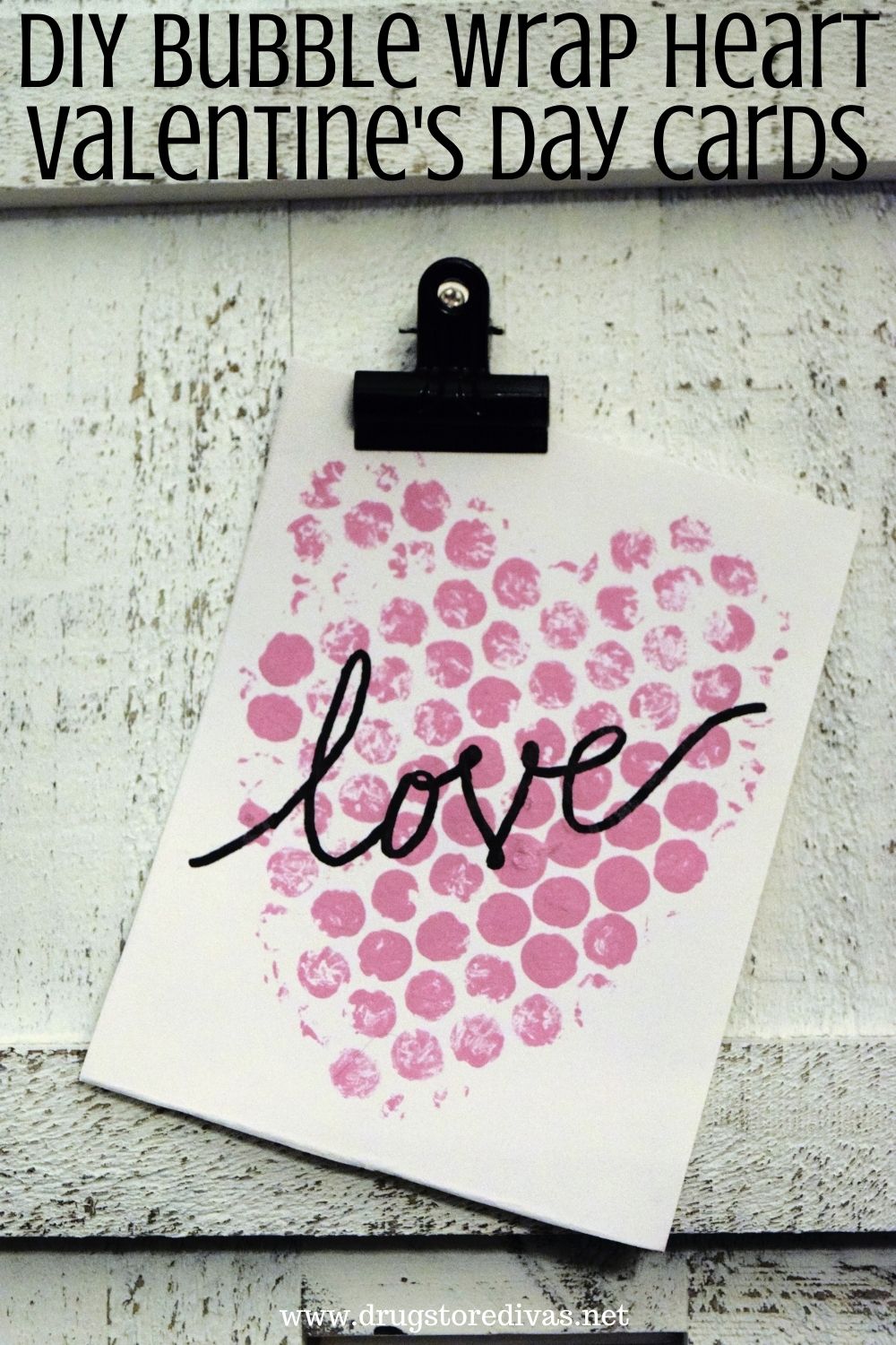 A homemade Valentine's Day card hanging on a clipboard with the words 