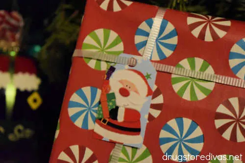 Homemade Santa Claus gift tag on a wrapped Christmas present.