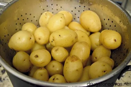 Many small potatoes in a collander.