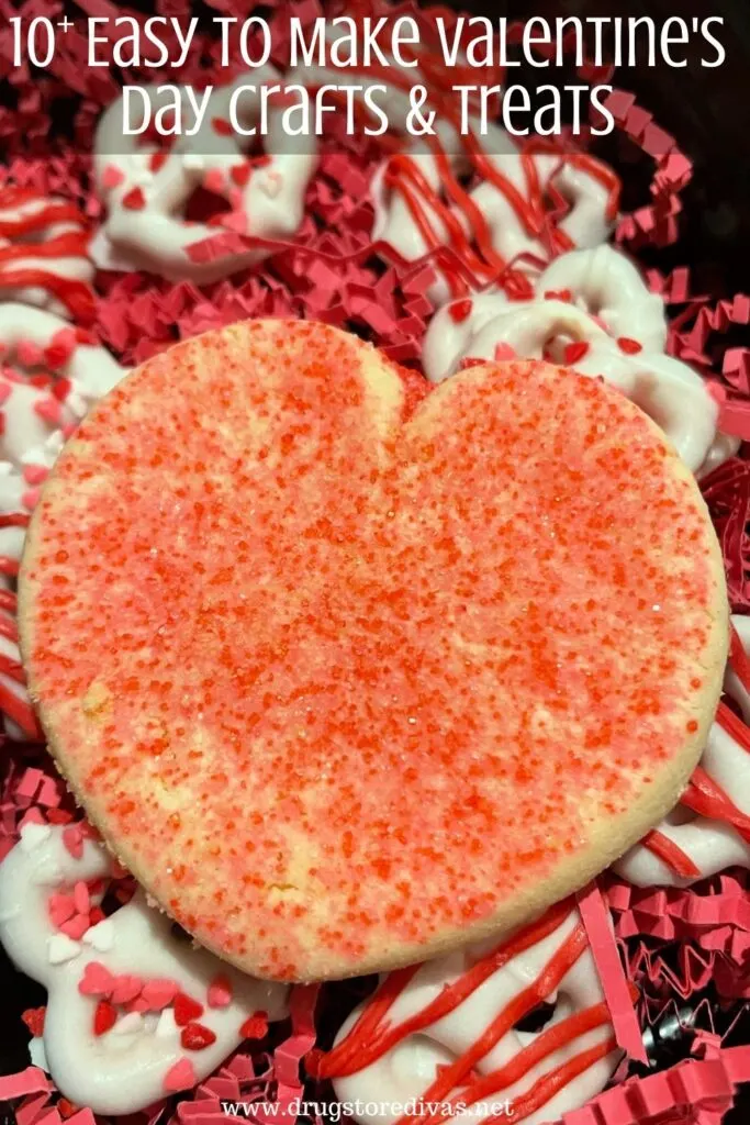 A heart-shaped sugar cookie and Valentine's Day pretzels in a box with the words "10 Easy To Make Valentine's Day Crafts & Treats" digitally written on top.