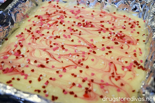 White fudge with pink swirls and heart-shaped sprinkles on it.