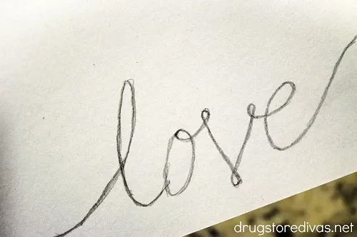 The word love written on cardstock.