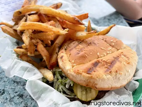 A burger and fries on a tray from PT's Grille in Leland, NC.