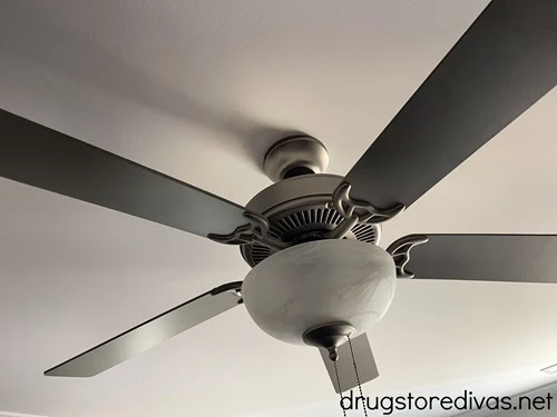 A ceiling fan hanging on a ceiling.