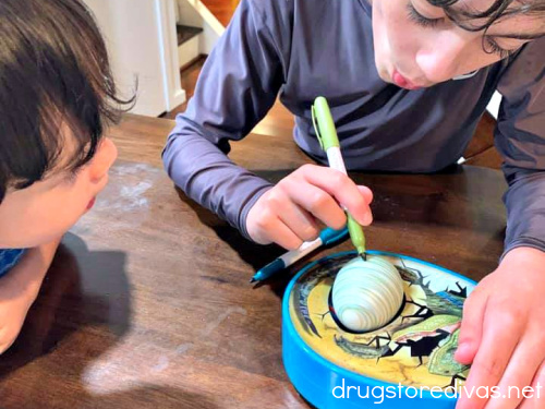 Two boys using the Dinomazing Egg Decorator.