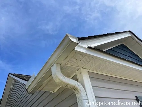 The corner of a home where you can see the gutters.