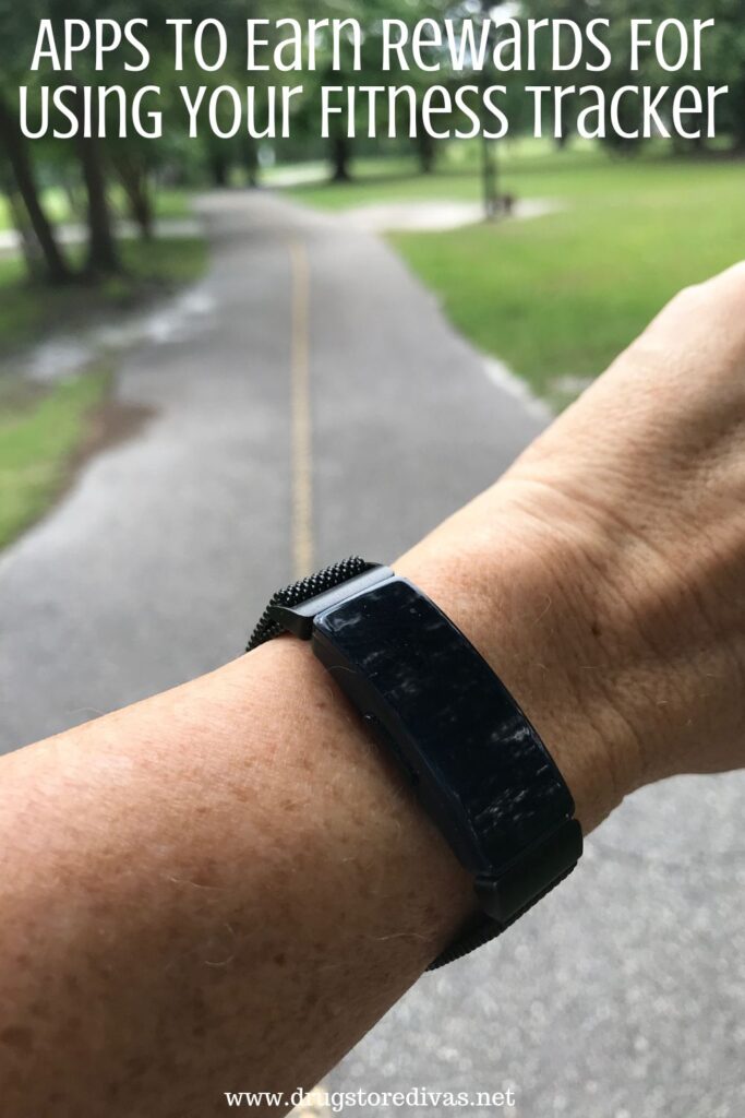 A woman wearing a fitness tracker with the words "Apps To Earn Rewards For Using Your Fitbit" digitally written on top.