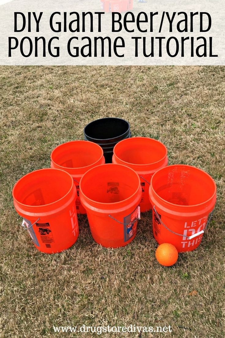 A DIY Giant Beer Pong game set up on a lawn with the words 