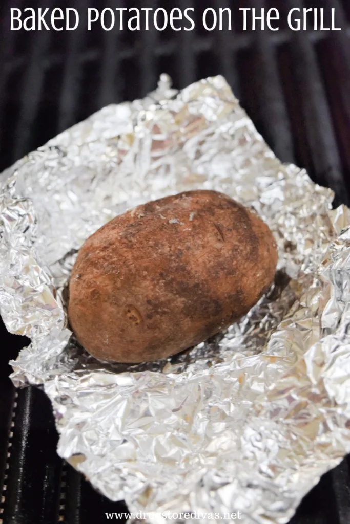 A potato in foil on the grill.
