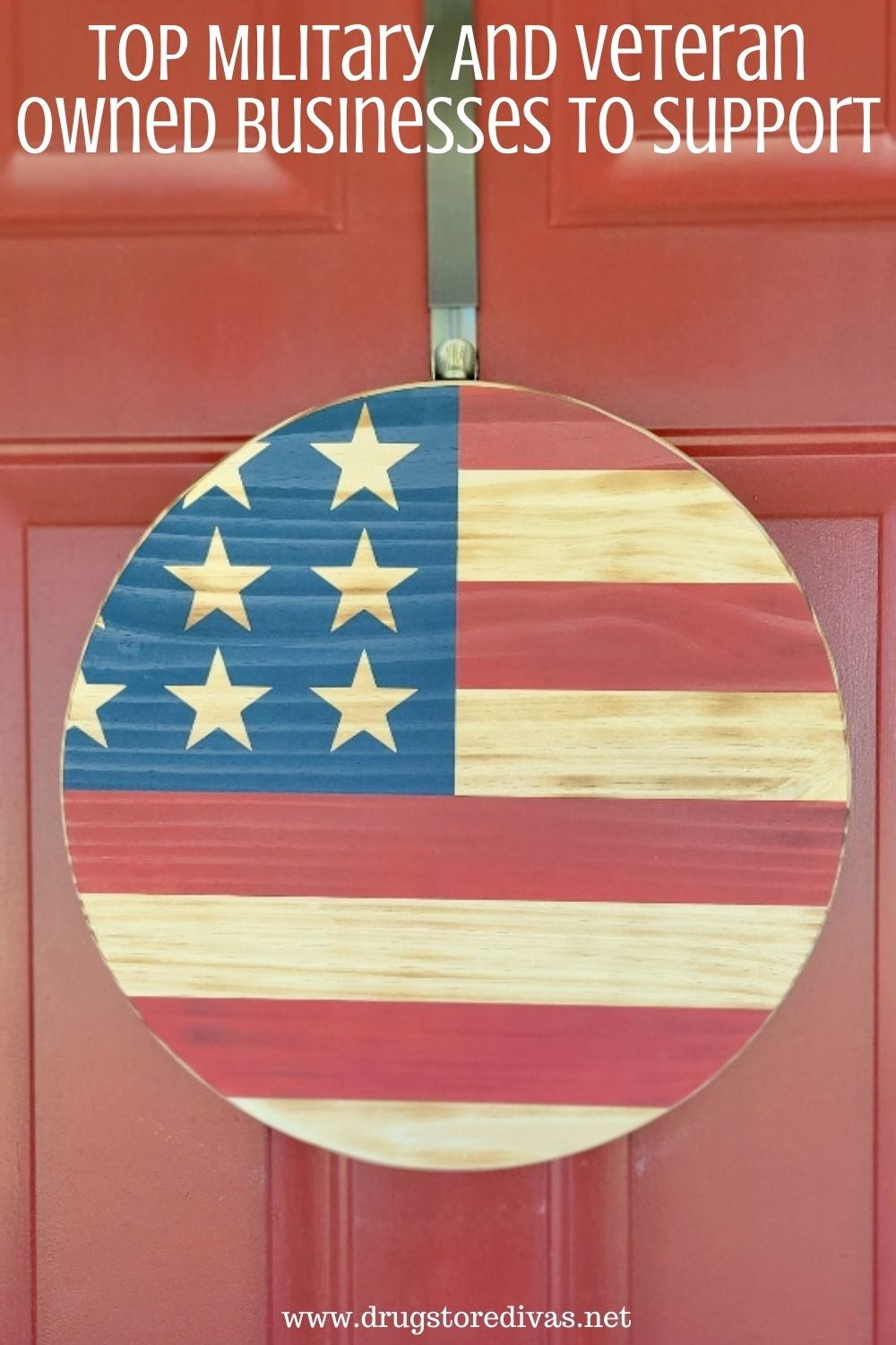 A wooden, circle door hanger painted to look like an American flag with the words 