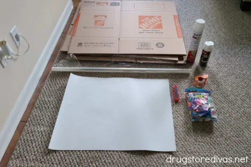 Boxes, cellophane, white paper, x-acto knife, spray paint, glue, and tape to make DIY baby blocks.