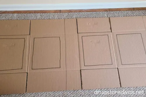 A flattened cardboard box with rectangles drawn on it.