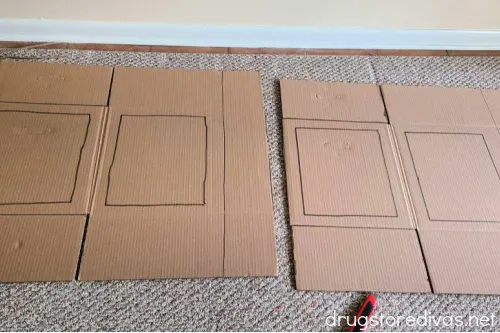 Two flattened cardboard boxes with rectangles drawn on them.