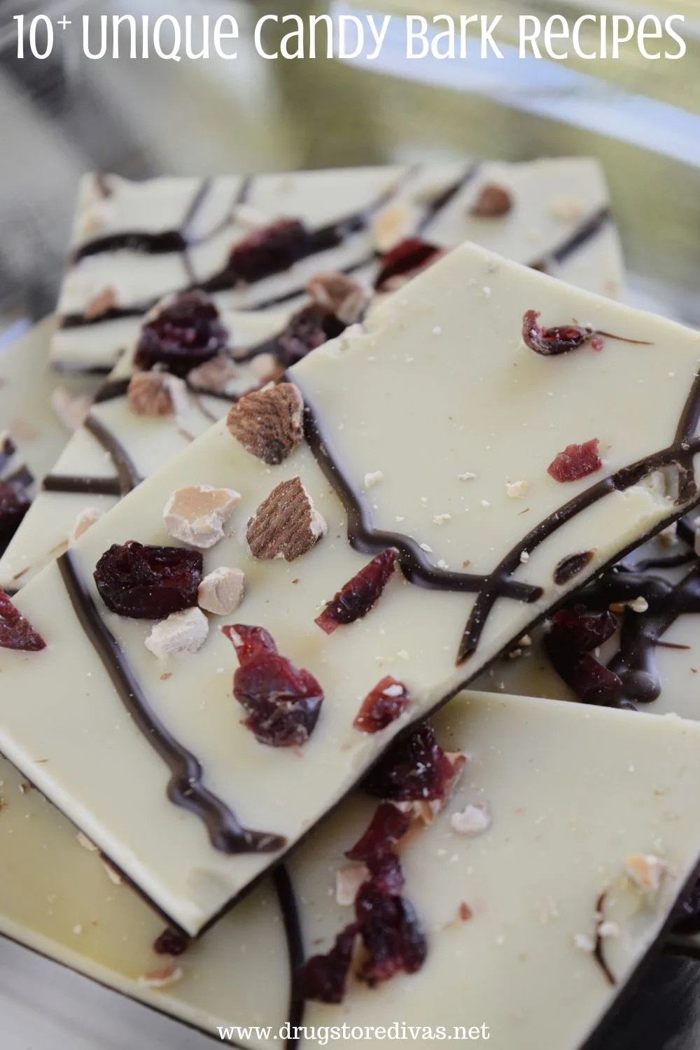 White chocolate bark with nuts and dried fruit and chocolate drizzles on top with the words 