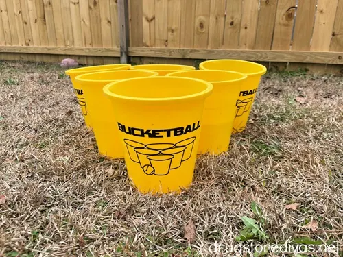 Six buckets set up for yard pong.