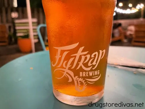 A pint of beer in a glass that says Flytrap Brewing on it.