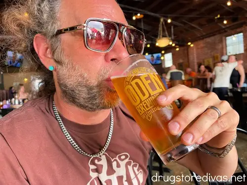 A man drinking a beer at Oden Brewing in Wilmington, NC.
