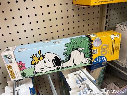 A Snoopy diamond art kit on a shelf.