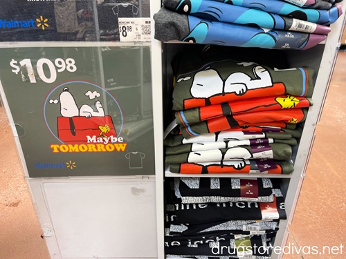 Snoopy t-shirts on a display in a store.
