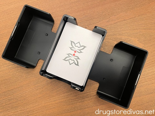 A card shuffler with a pack of cards in the center.