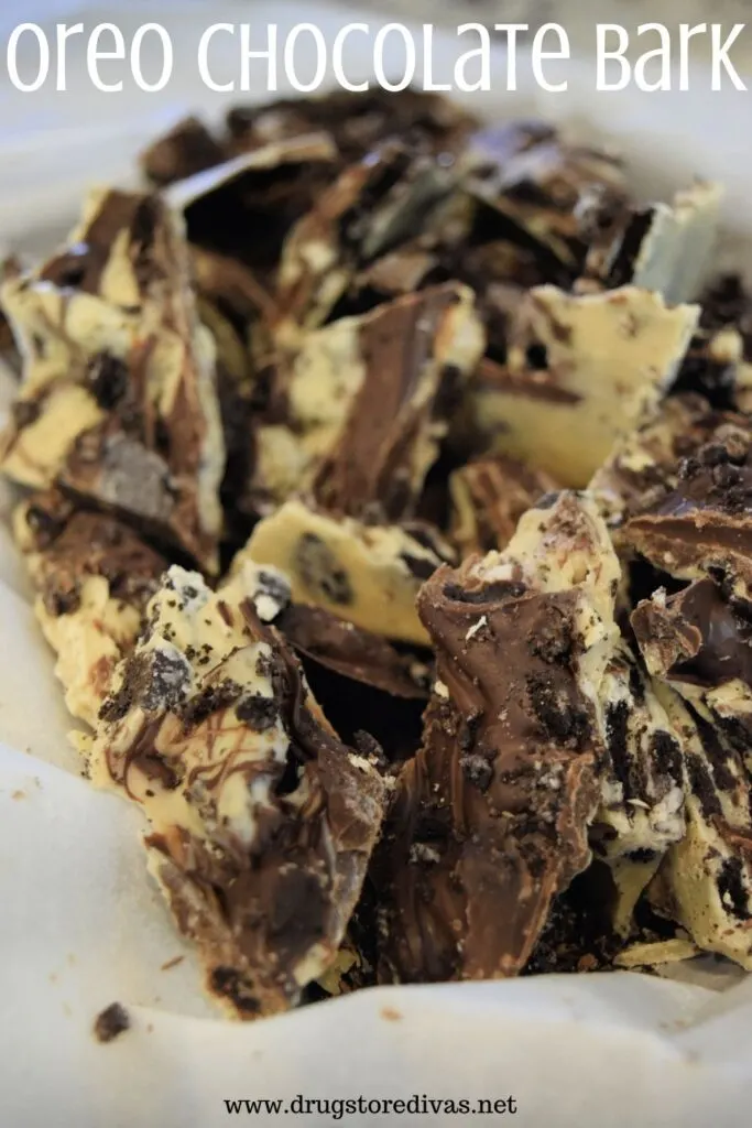 Pieces of Oreo chocolate bark in parchment paper with the words "Oreo Chocolate Bark" digitally written above it.