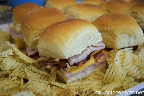 Turkey Club Hawaiian Roll Sliders on a plate with chips.