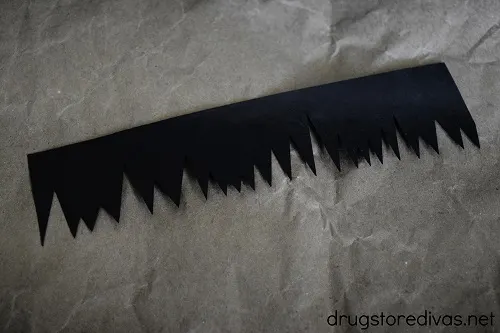 Piece of black cardstock cut to look like bangs.