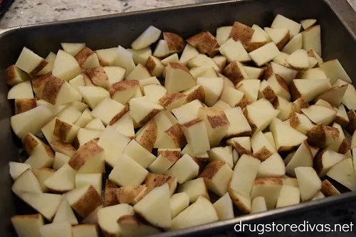 Potato pieces in a baking pan.