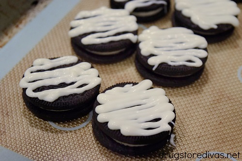 Oreo cookies with a zigzag of almond bark on top.