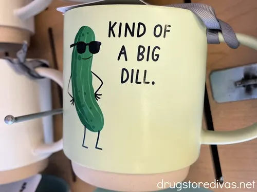 A mug with a pickle on it that says Kind Of A Big Dill.