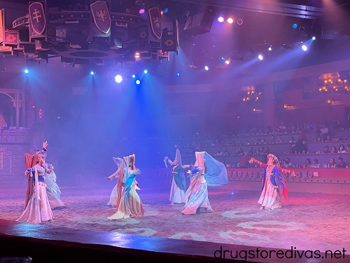 Seven women, dressed liked maidens, dancing in the Tournament of Kings arena.