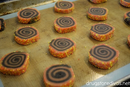 Halloween pinwheel cookies on a baking sheet.