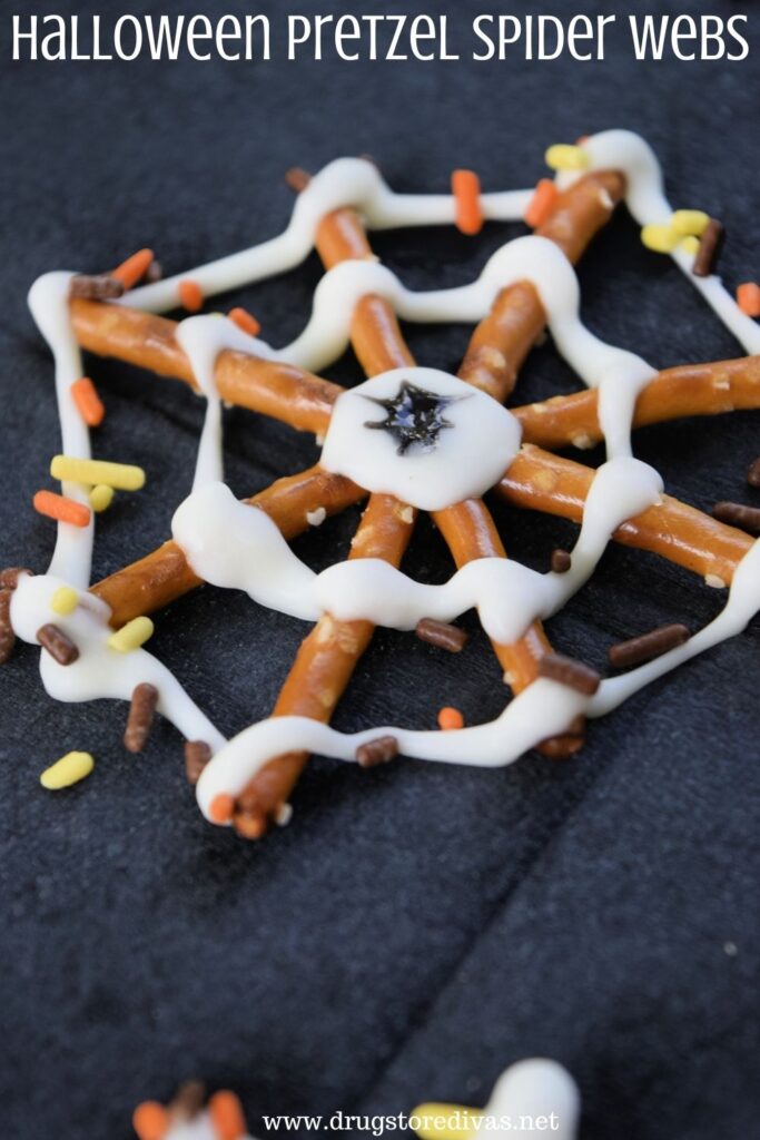 Chocolate and pretzel spider web treat with the words "Halloween Pretzel Spider Webs" digitally written on top.