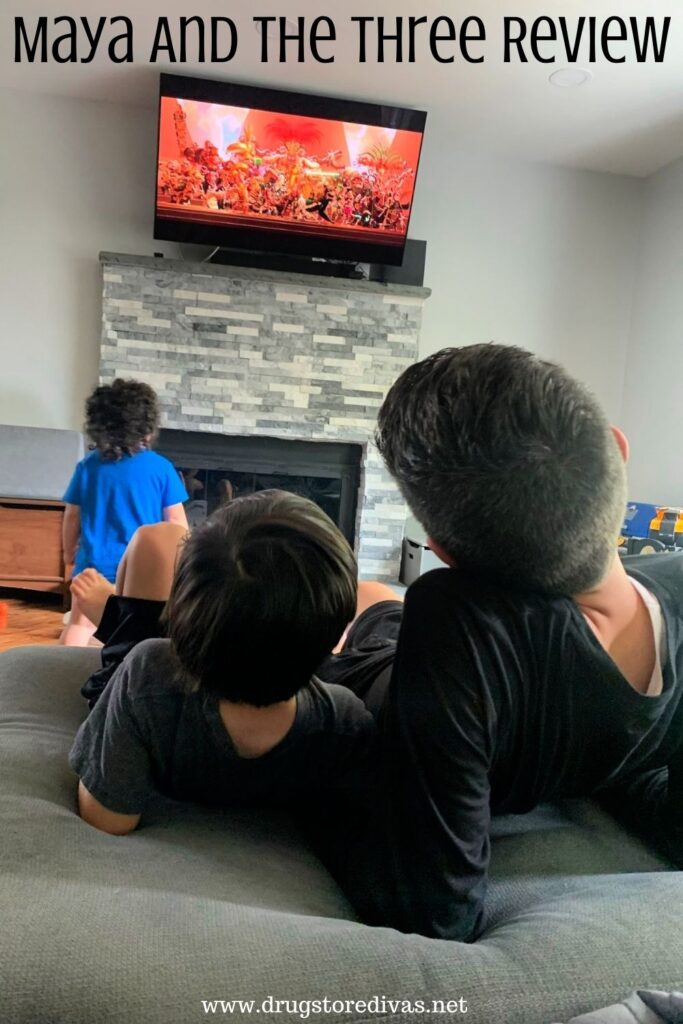 Three boys watching television.