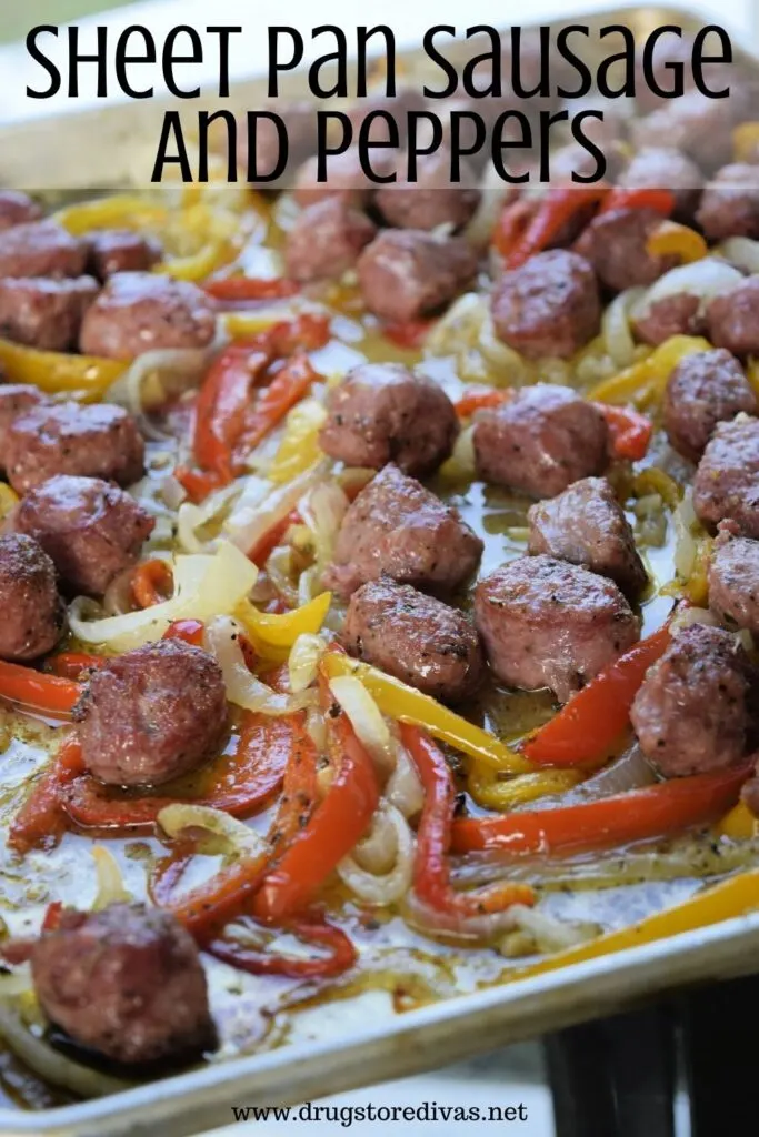 Sausage and peppers on a sheet pan with the words "Sheet Pan Sausage And Peppers" digitally written on top.
