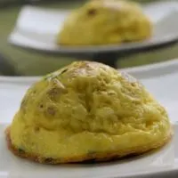 Two egg bites, on plates, with the words 