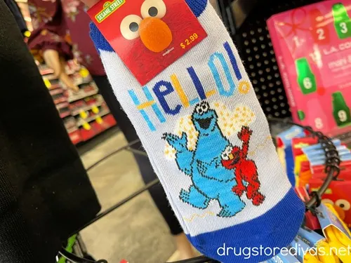 A pair of socks with Cookie Monster and Elmo on them.